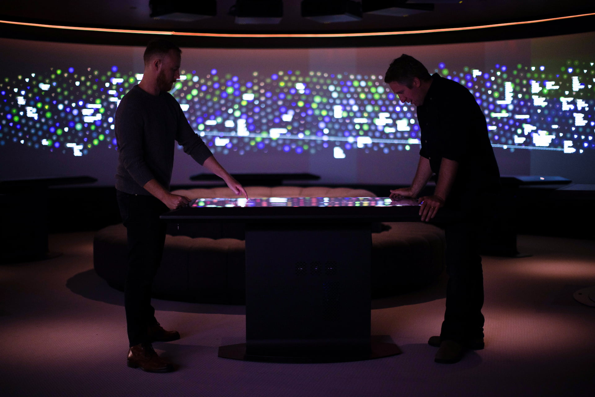 Touch table interactive Two men opposite the Constellation exhibition.