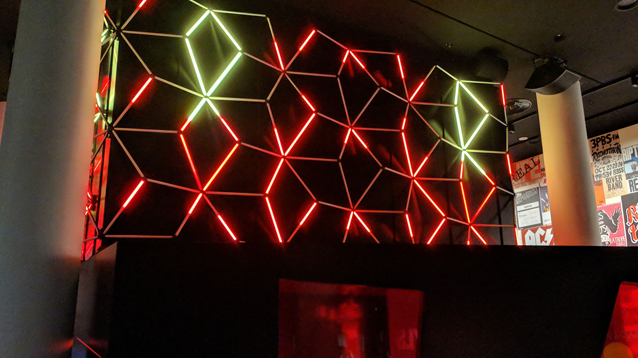 Digital light sculpture Colourful lights of red and white changing above the exhibition.