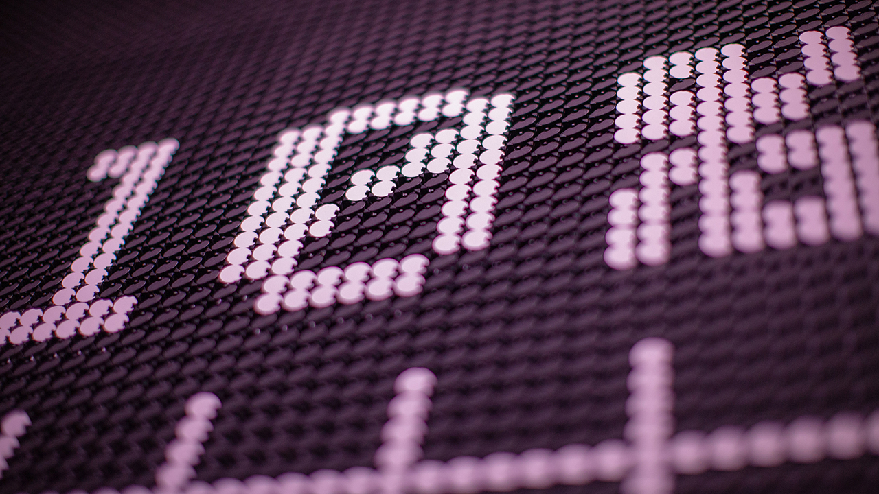 Close up of black and purple flip dot screen reading 10 percent. 
