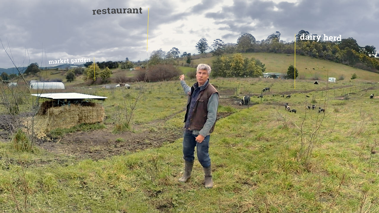 Film set on farm Matthew Evans in a paddock with dairy pigs in the background.