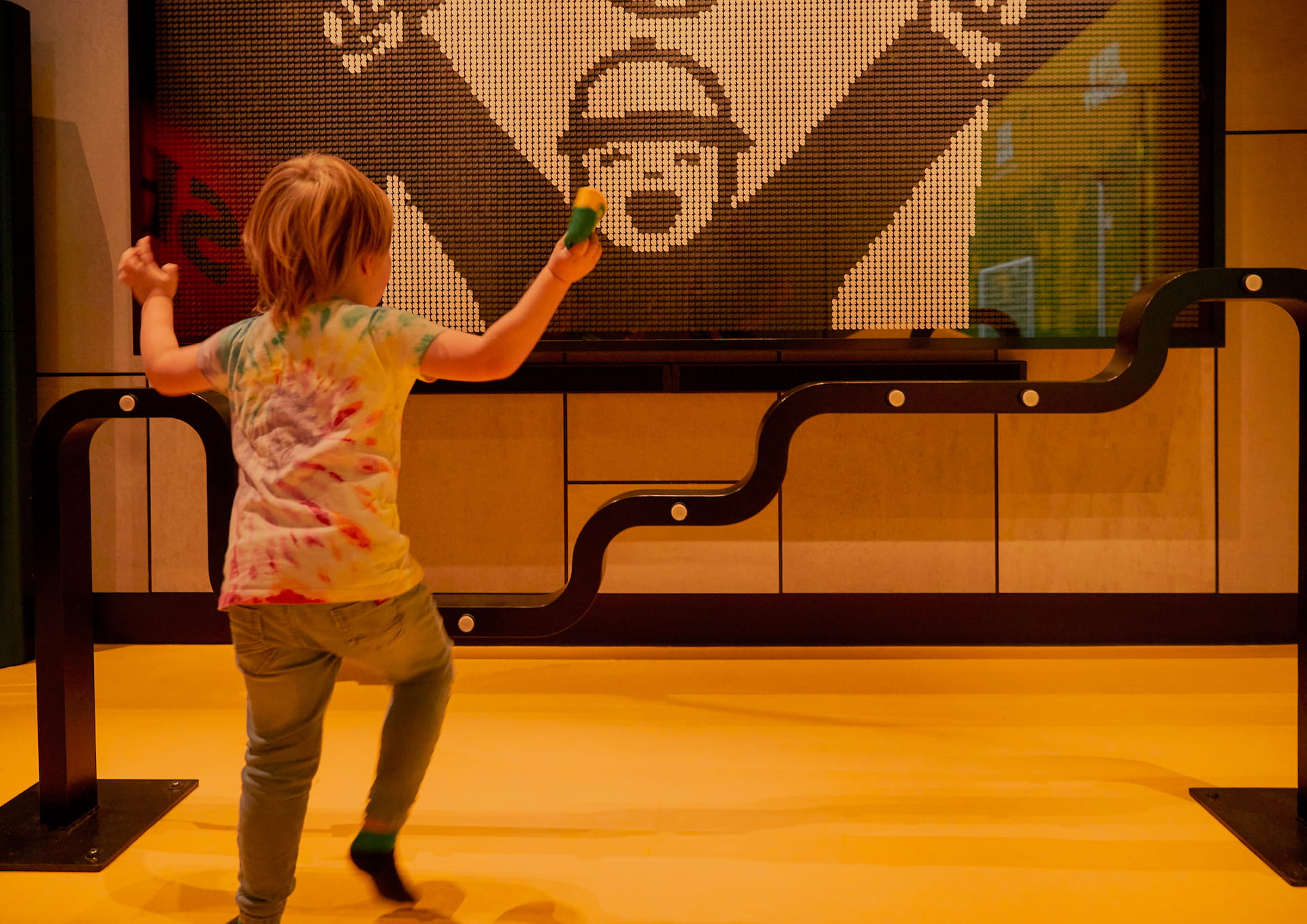 Interactive sports installation Child mirroring pose on screen opposite her.