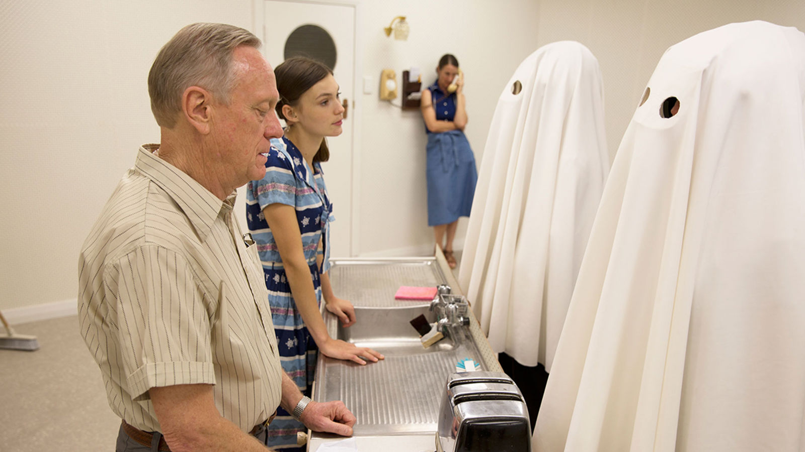 film set for vr experience Man and woman talking to ghosts over a kitchen sink.