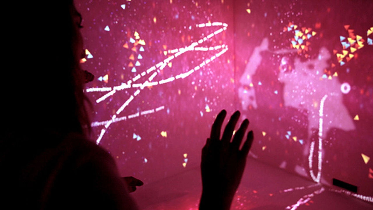Light installation People interacting with full-room projections as part of the installation.