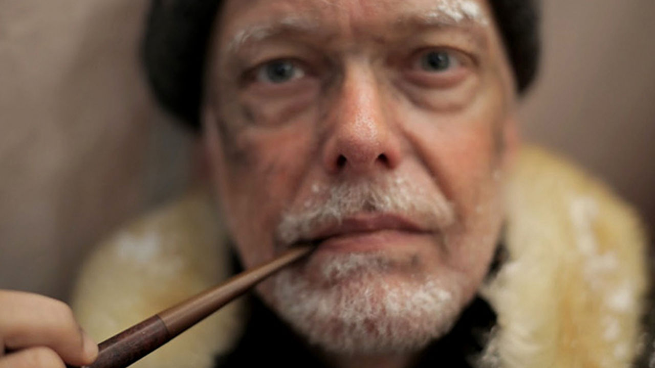Google hangouts in history Close-up of an older man smoking a pipe.