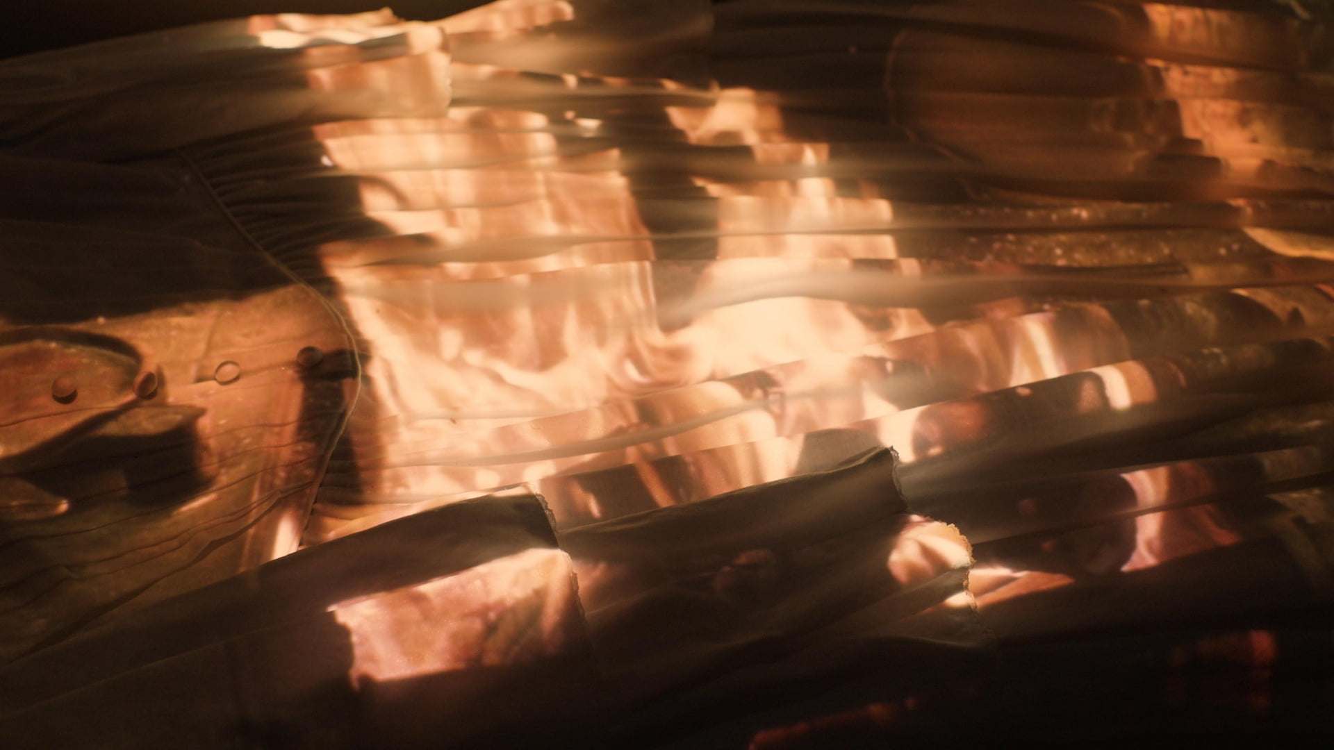 Projection installation Fire projected onto rippling fabric.