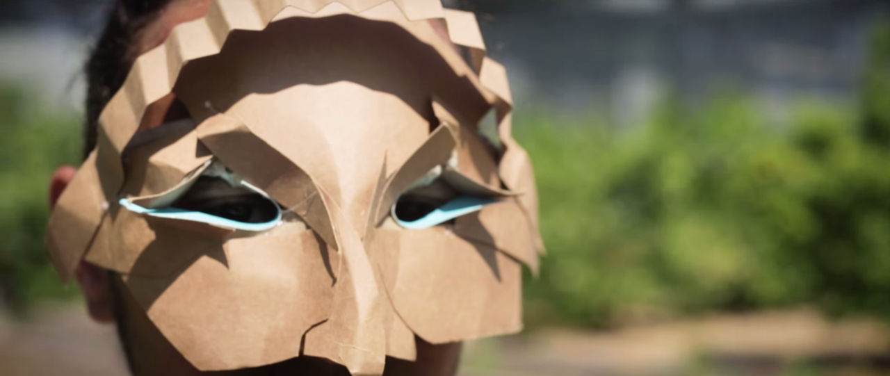 Actor on set Close-up of man wearing cardboard mask.