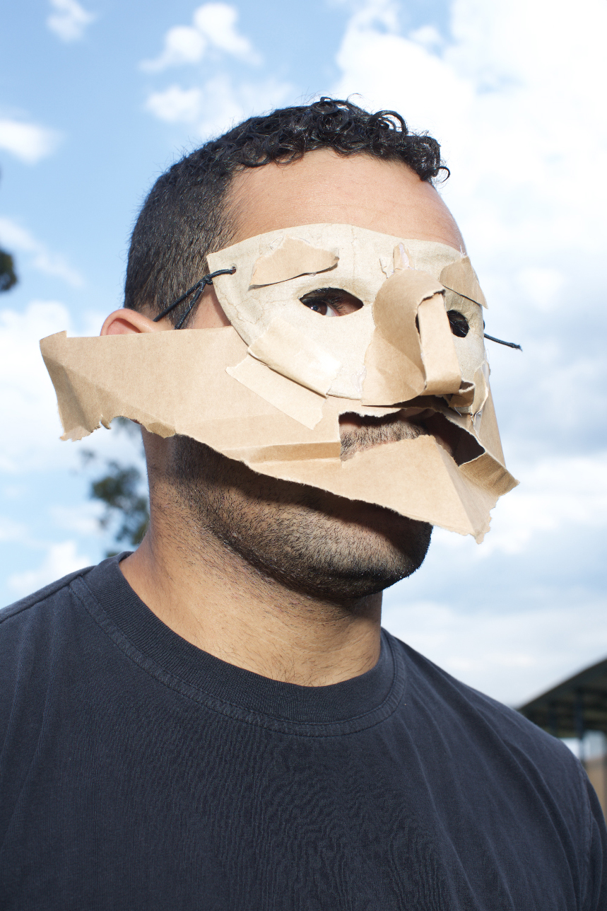 Shakespearean performance Medium-shot of man wearing cardboard mask.