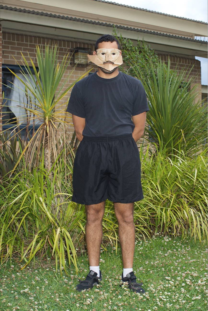 Shakespearean performance Full-shot of man wearing cardboard mask.