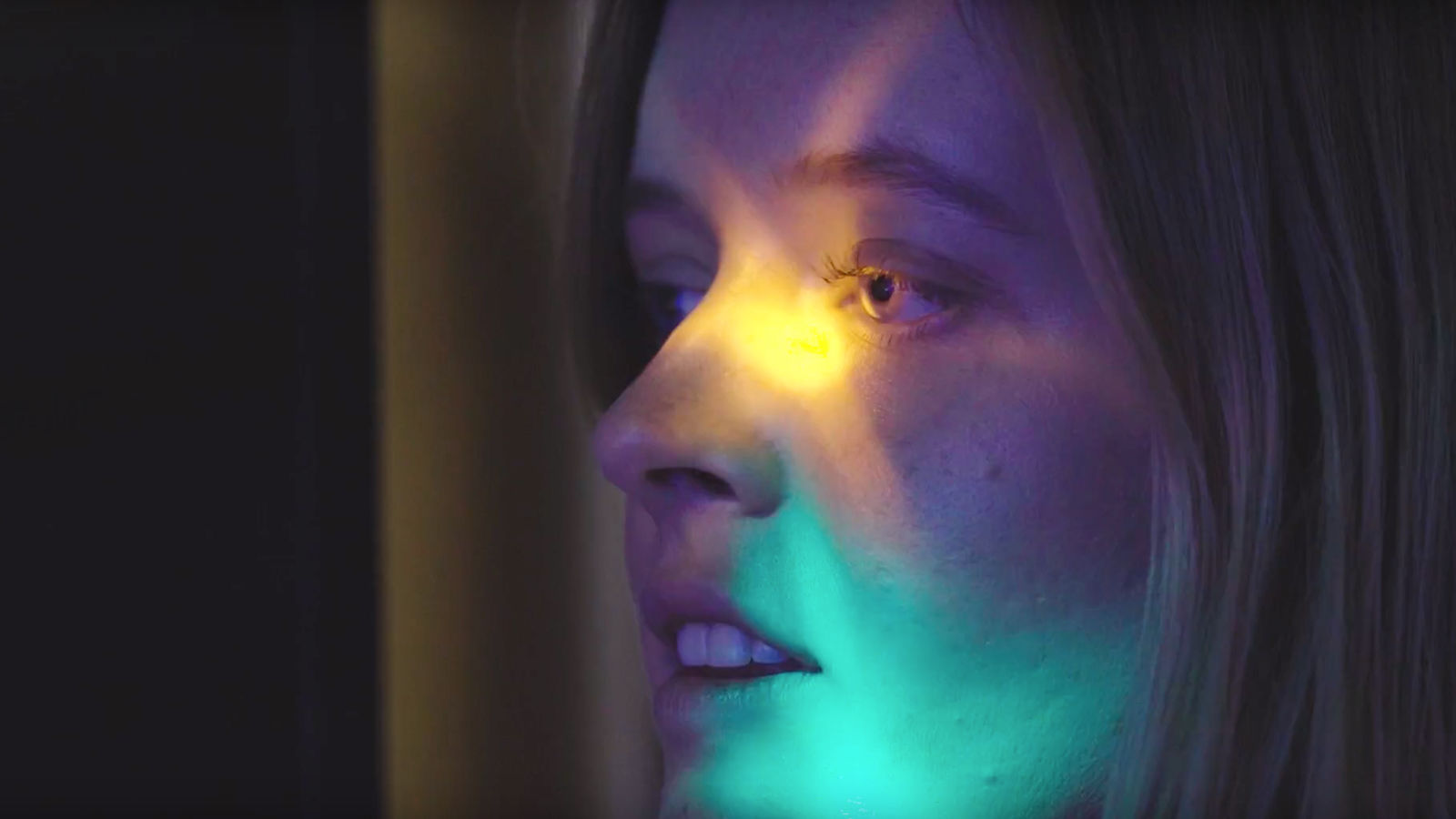 Interactive film installation Close-up of woman with light.