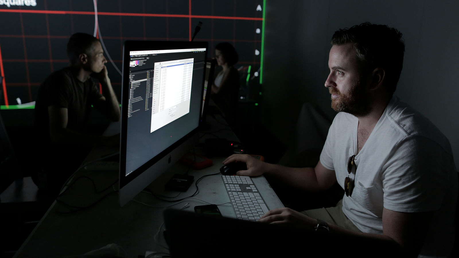 Projection-mapping development Midshot of developer on iMac.