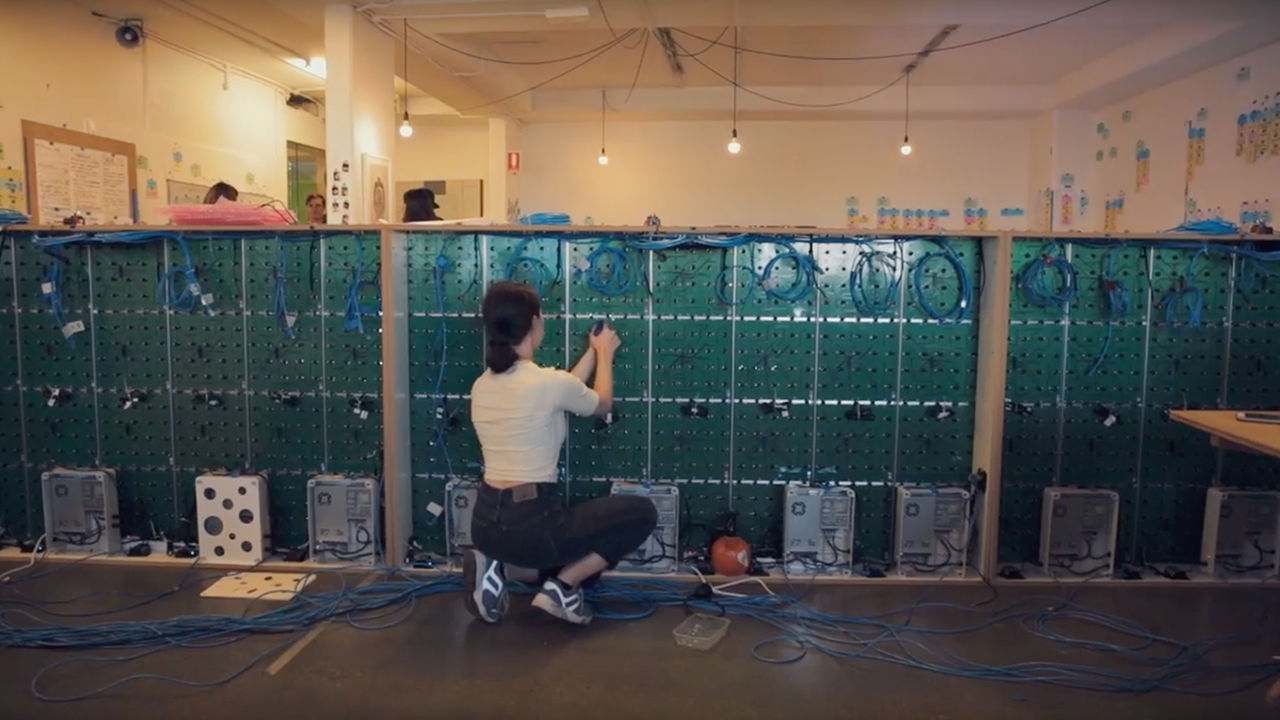 Pixel wall installation Woman wiring cables to the pixel interface.