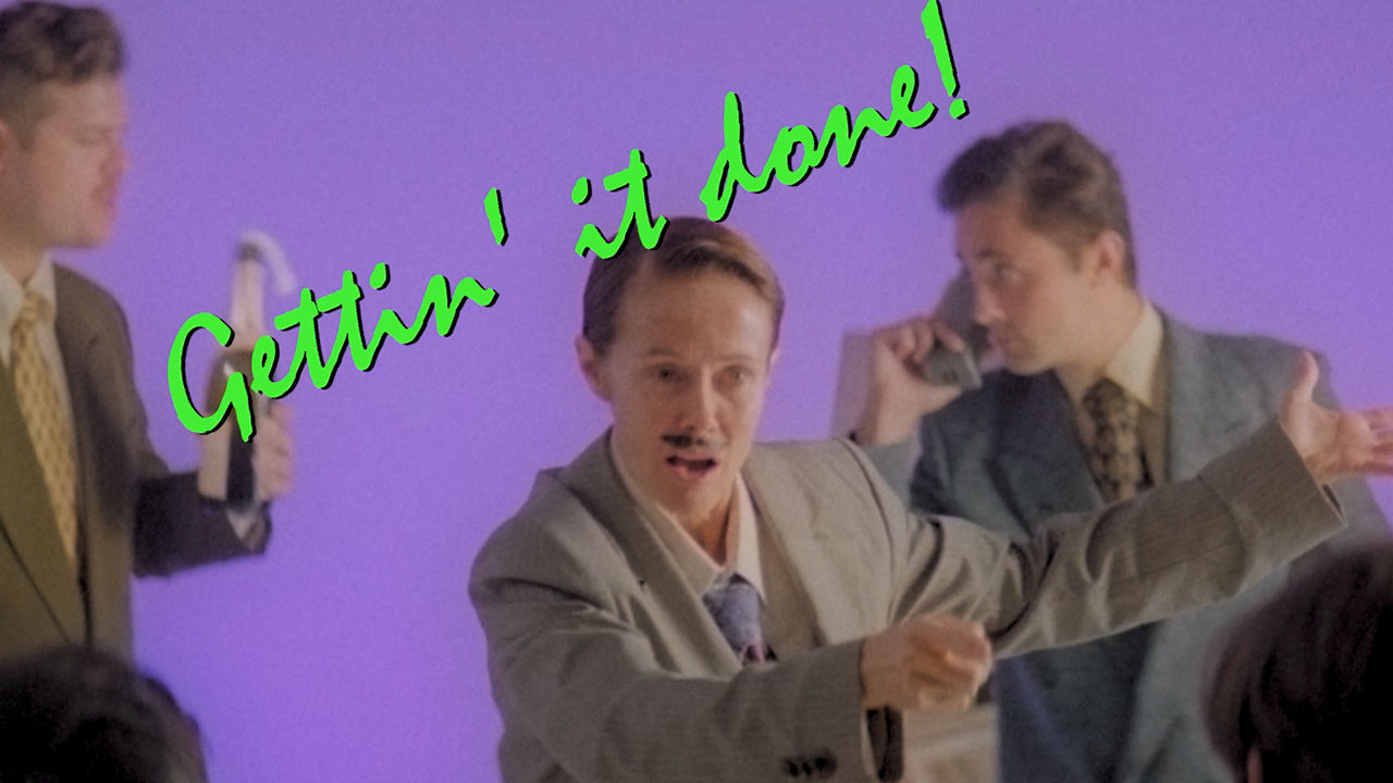 Actors Man with fake moustache, caption reads getting it done.