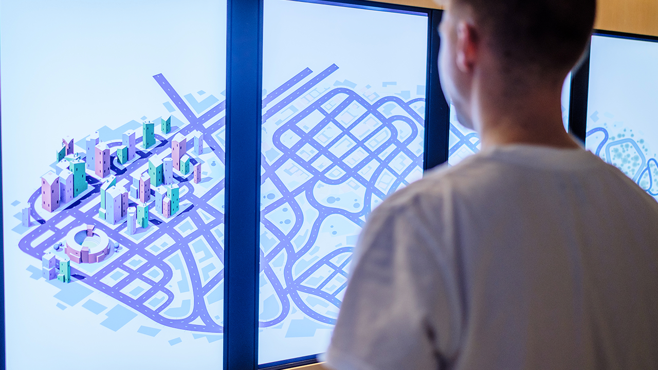 Data visualisation interaction Vertical screens show a stylised city with connected roads.