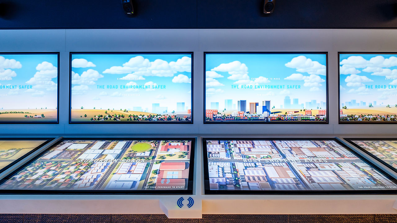 Horizontal touchscreens display different road types with an NFC reader prompt.