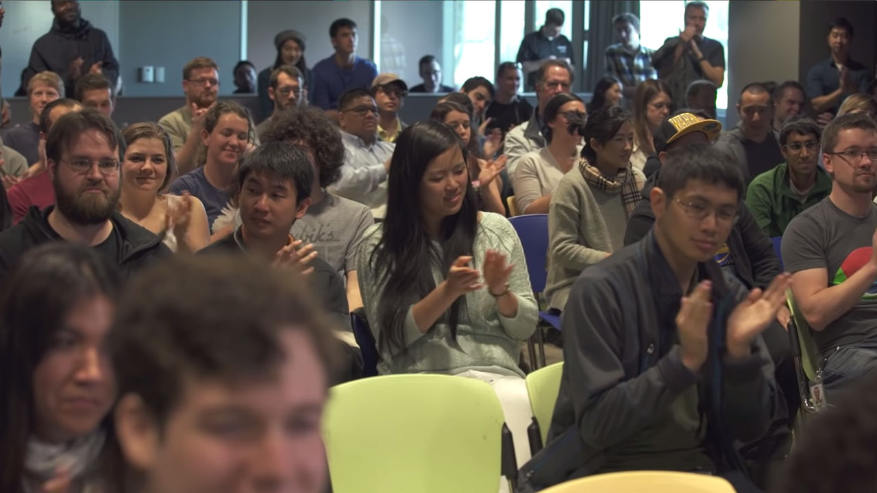 Talks at Google Diverse audience clapping during Google Talks presentation.