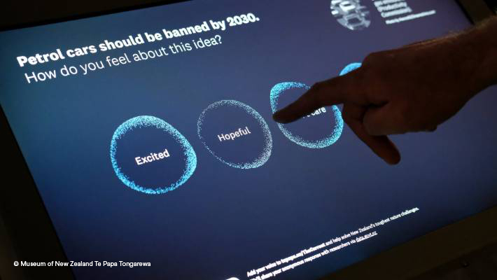 Touchscreen in Te Papa Hand touching 'hopeful' option on touchscreen.