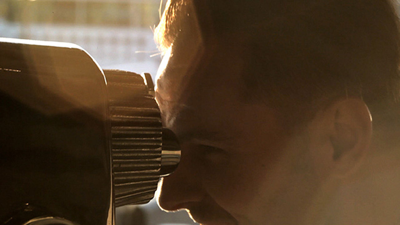Binocular experience Man looking through physical binoculars.
