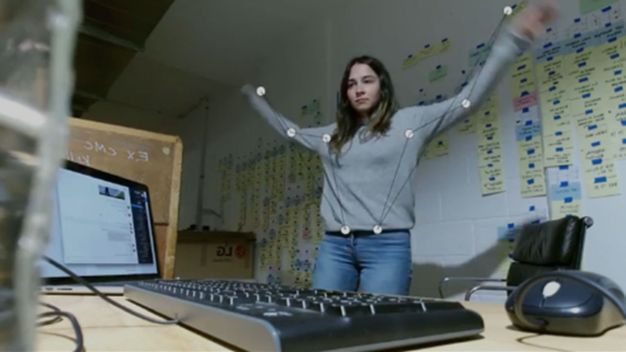 Microsoft Kinects programmable wings Woman with hands raised, pivot points are mapped over the top.